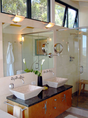 Double vessel sinks and glass enclosed shower.  Clerestory windows bring in natural light