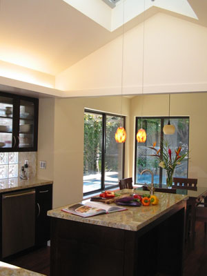 Kitchen island with vaulted ceiling and skylight