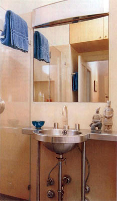Stainless steel bathroom sink and mirror.  Careful attention to detail and a limited palette of materials give the design a simple, clean aesthetic.