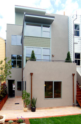 Rear exterior.  The kitchen and family room have direct access to a dining terrace and rear yard.  A garden apartment at the ground floor has its own entry and private patio.