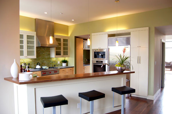 View of kitchen from family room.  A dining bar and butler's pantry are two features of this kitchen.
