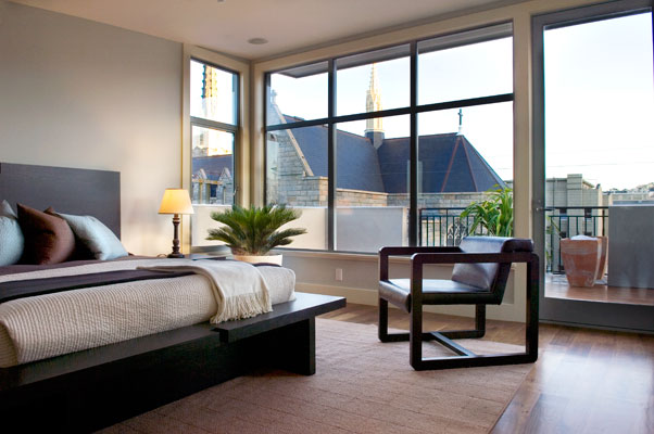 Master suite penthouse with expansive windows and rooftop deck.
